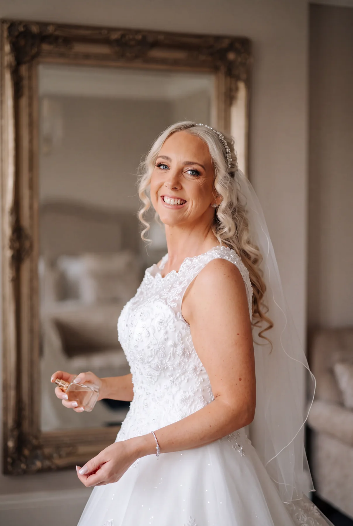 A smiling bride in soft window light
